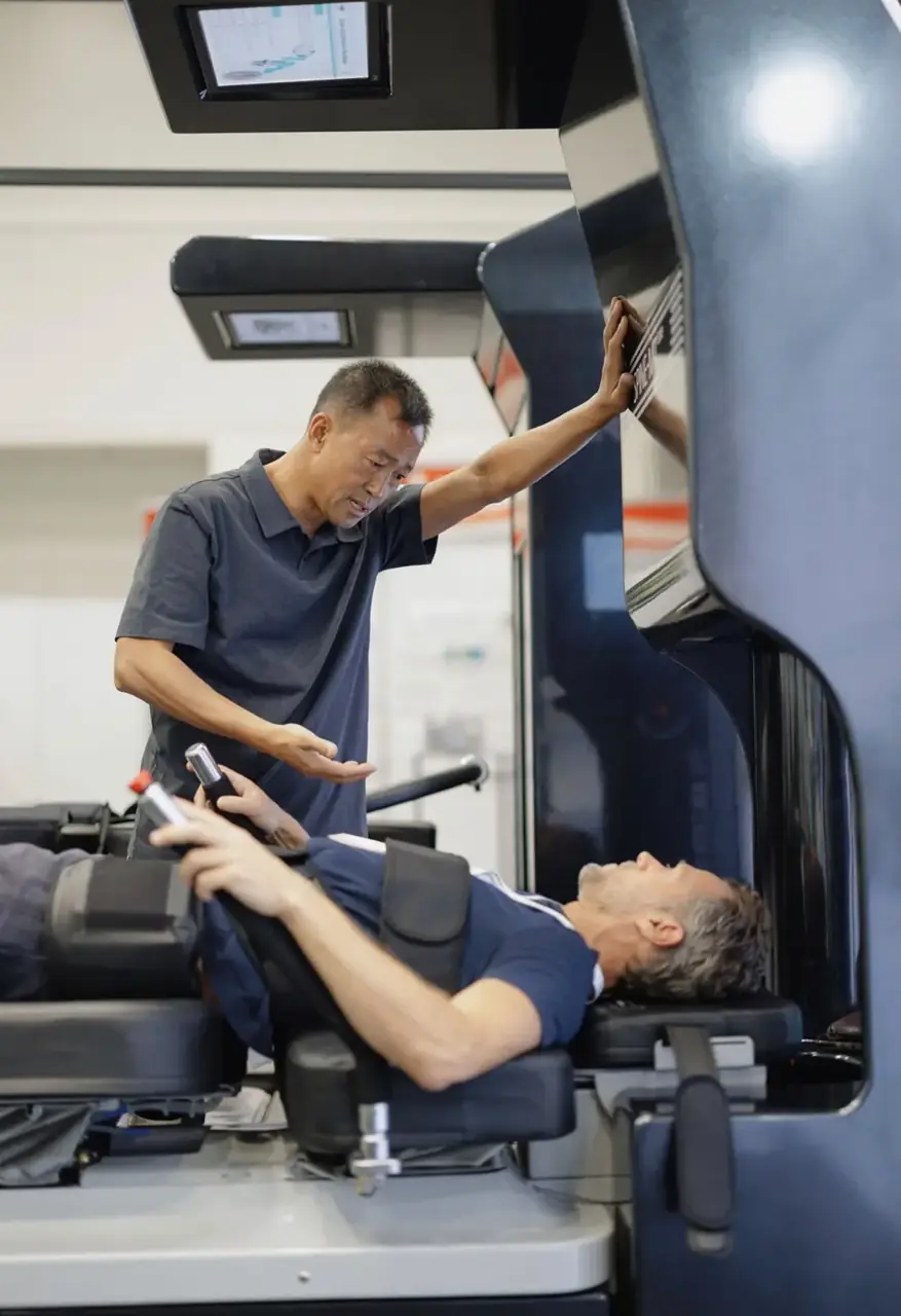 A practitioner guiding a patient through a session on the Spine Series